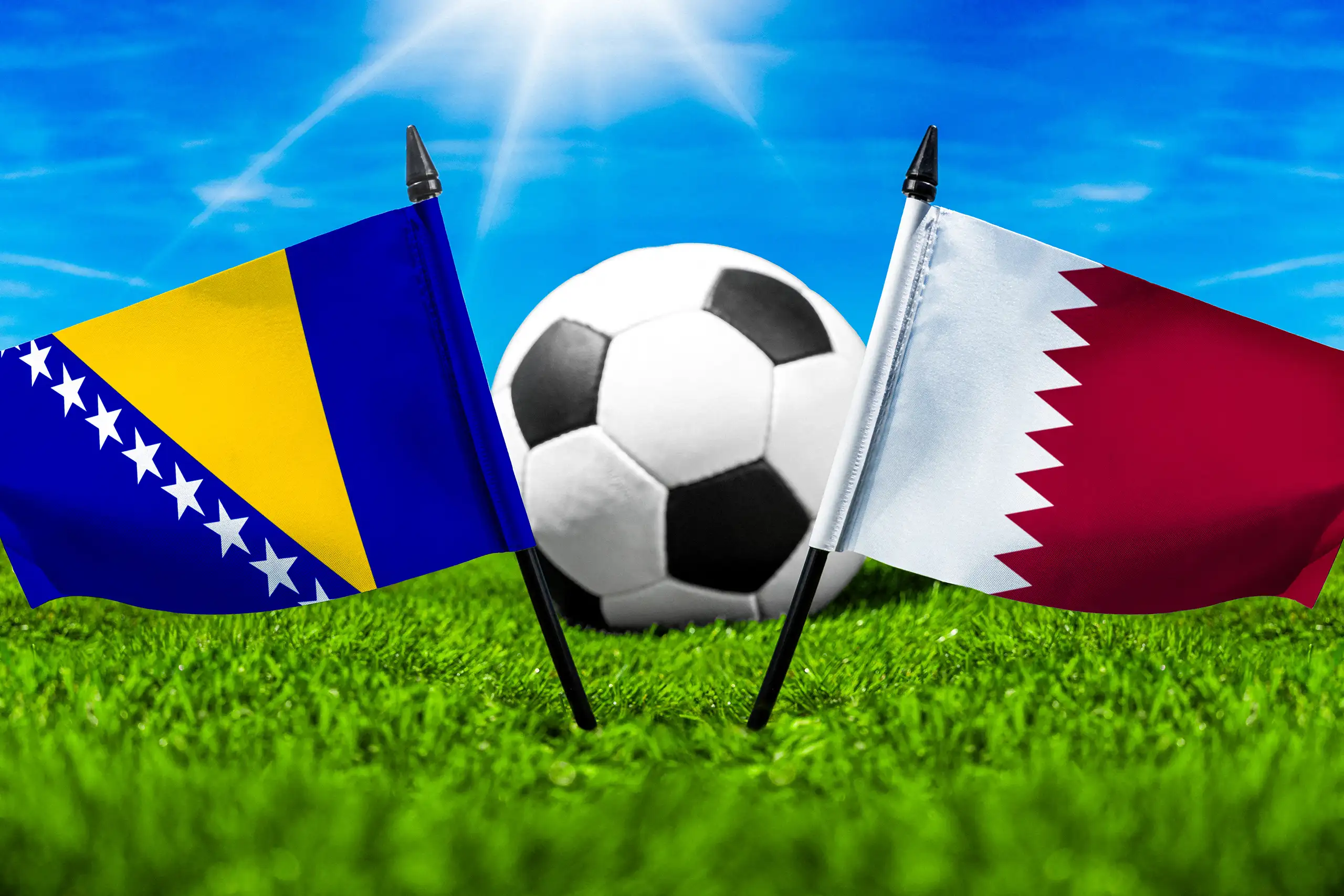flaggen von bosnien und herzegowina und katar mit fußball auf grünem rasen unter blauem himmel.