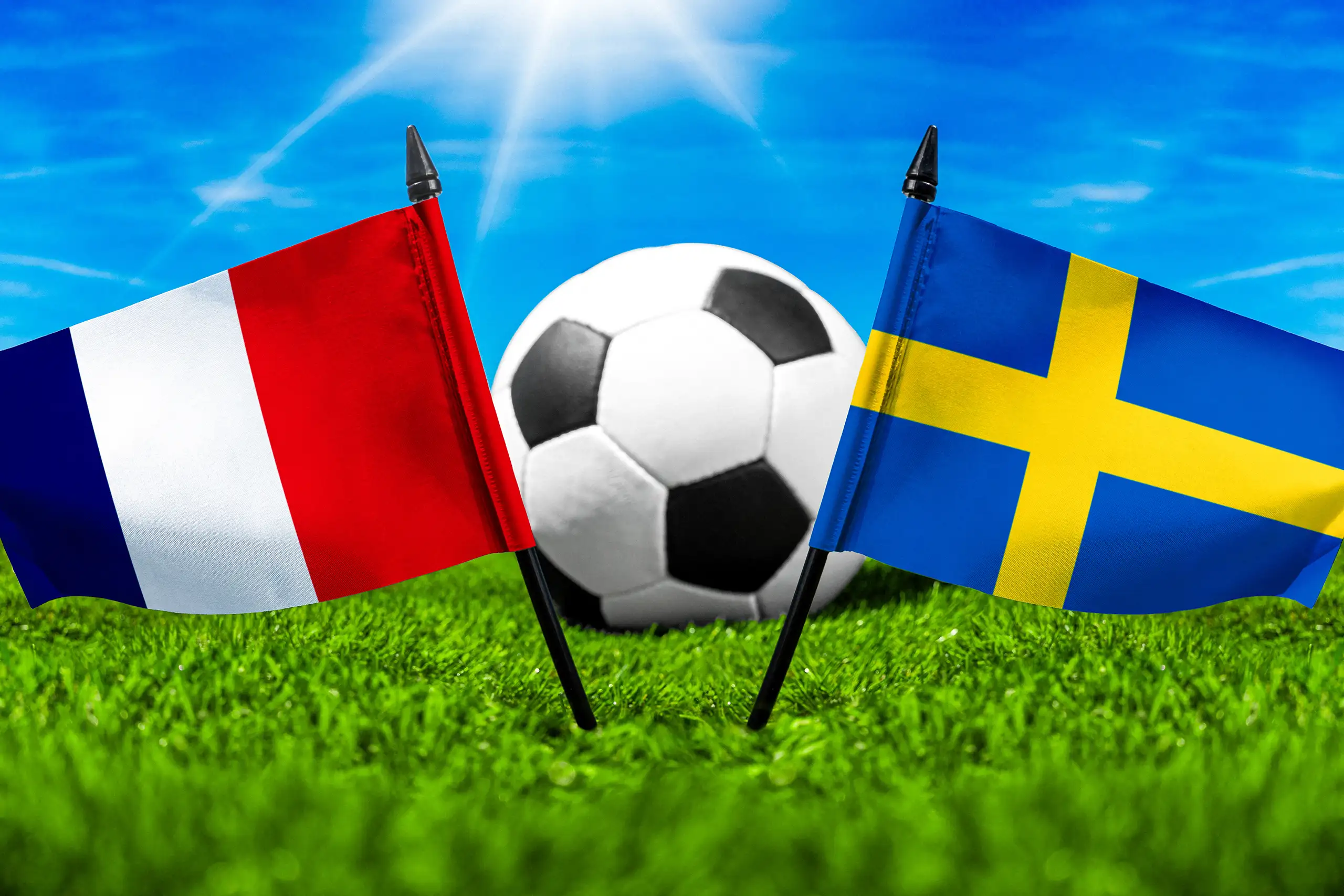frankreich gegen schweden mit nationalflaggen und fußball auf grünem rasen bei einer internationalen fußballbegegnung.