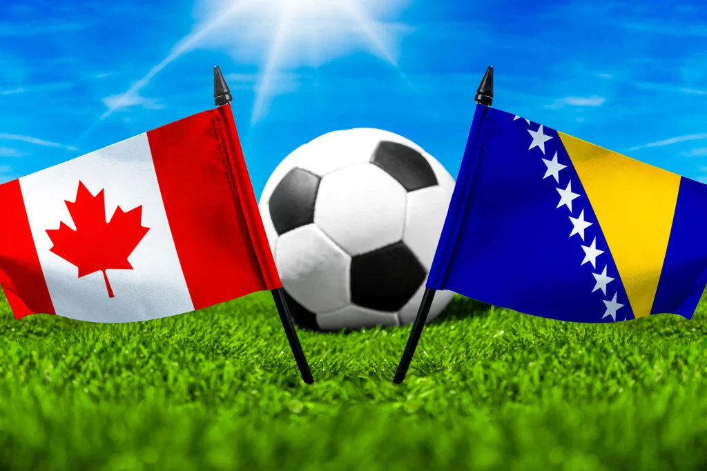 Kanada gegen Bosnien und Herzegowina mit Fußball auf Rasen und den Nationalflaggen beider Länder unter blauem Himmel.