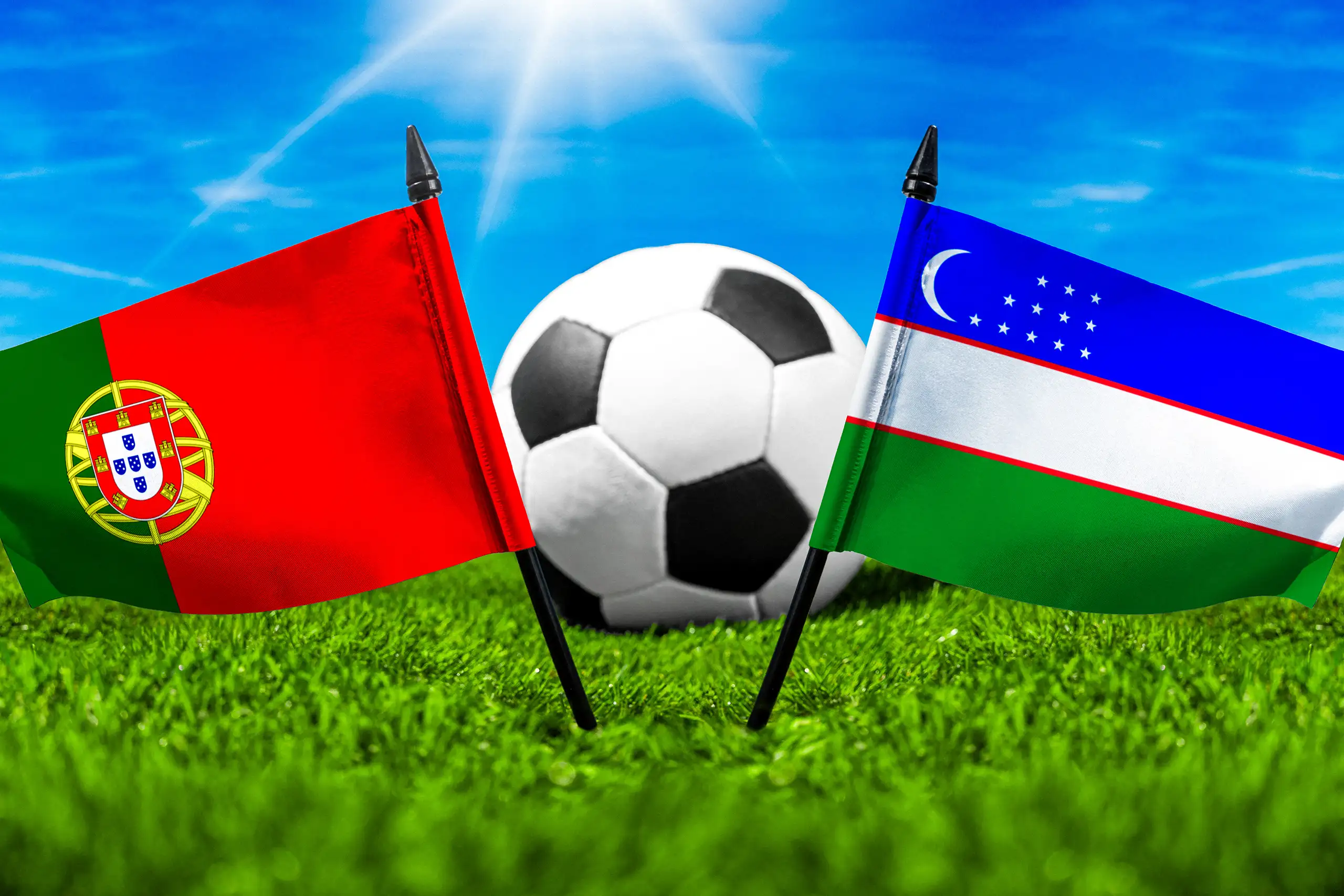 portugal gegen usbekistan mit nationalflaggen und fußball auf einem grünen fußballfeld unter blauem himmel.