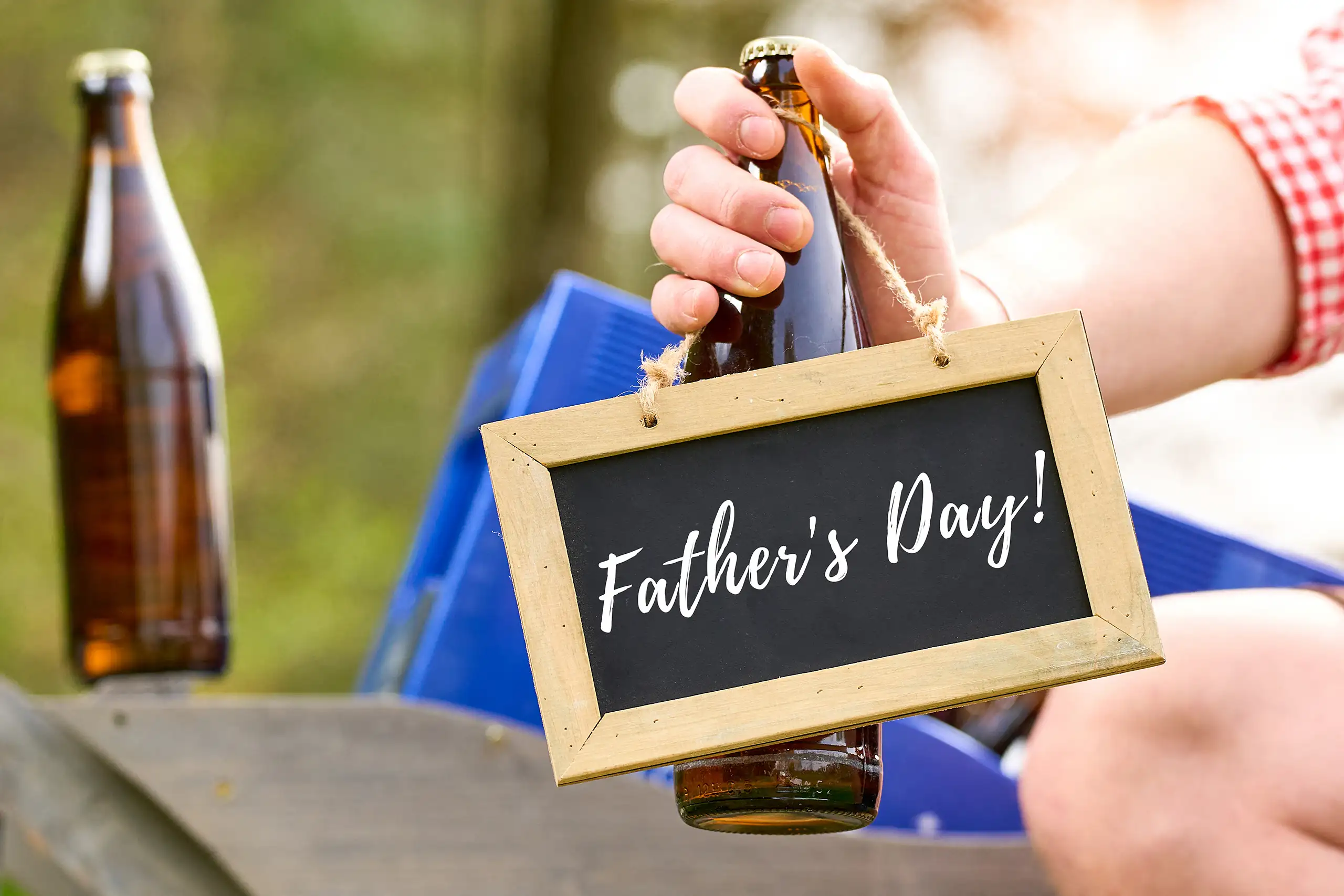 FATHERS DAY GREETING BILDER father's day greeting sign hanging from a beer bottle held outdoors