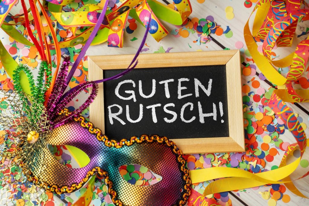Guten Rutsch! Silvestergruß mit Luftschlangen