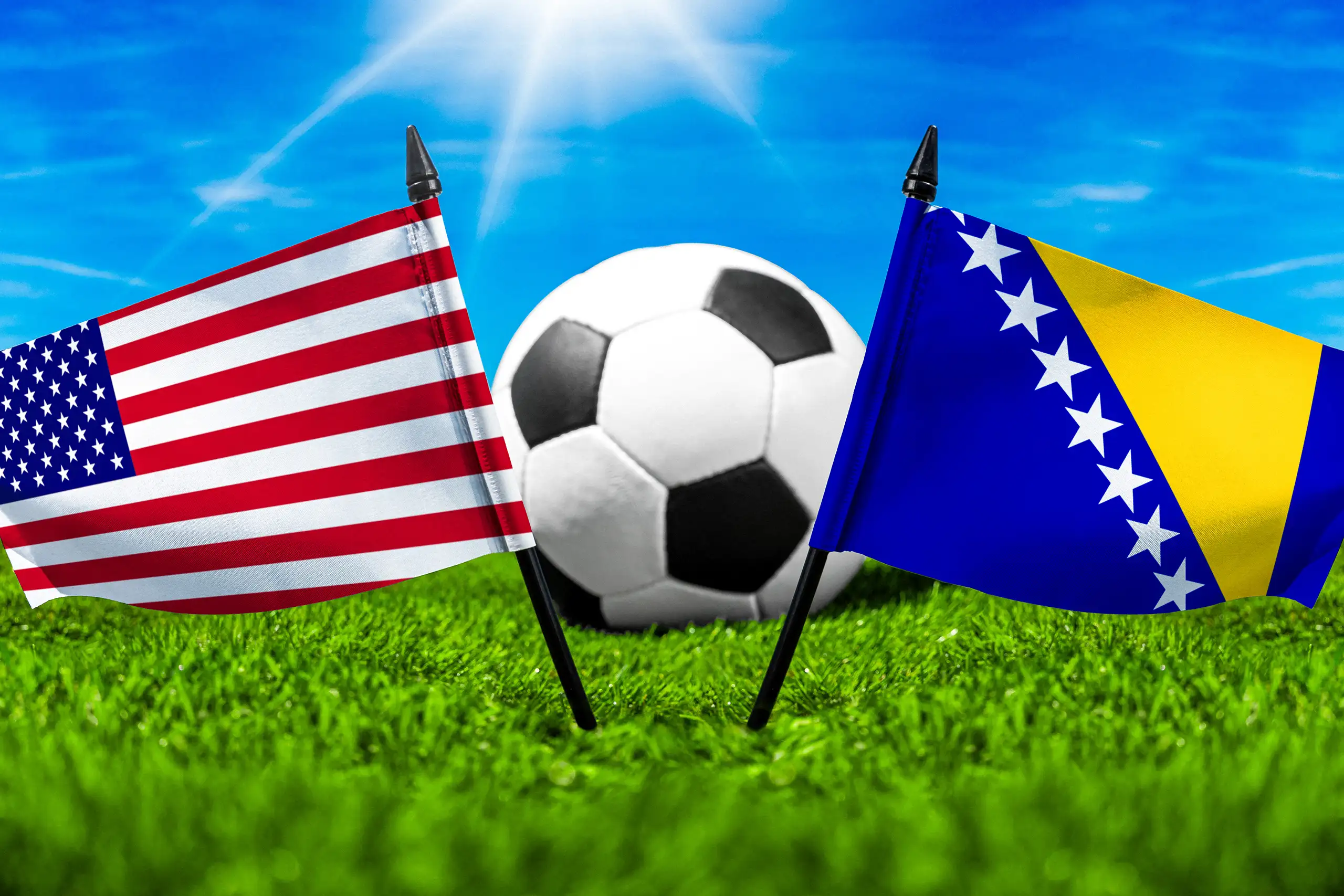 usa gegen bosnien und herzegowina mit nationalflaggen und fußball auf grünem rasen bei einem internationalen fußball-länderspiel.